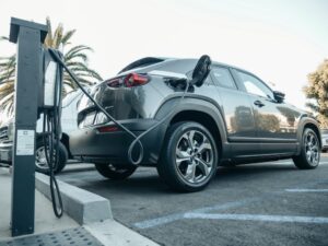 A sleek electric vehicle charging at a state-of-the-art EV charging station in Vancouver.